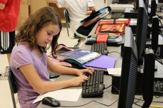 Student using a laptop in a classroom