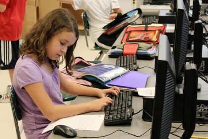 Student using a laptop in a classroom