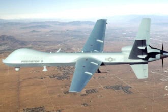 Unmanned military aircraft flying over desert training range