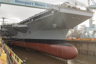 USS John F. Kennedy aircraft carrier under construction in a Virginia drydock.