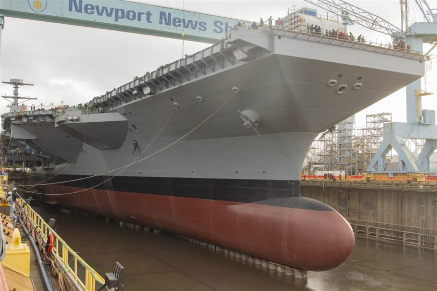 USS John F. Kennedy aircraft carrier under construction in a Virginia drydock.