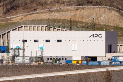 High-voltage electrical transformers, insulators, and transmission lines at a bulk-power grid substation