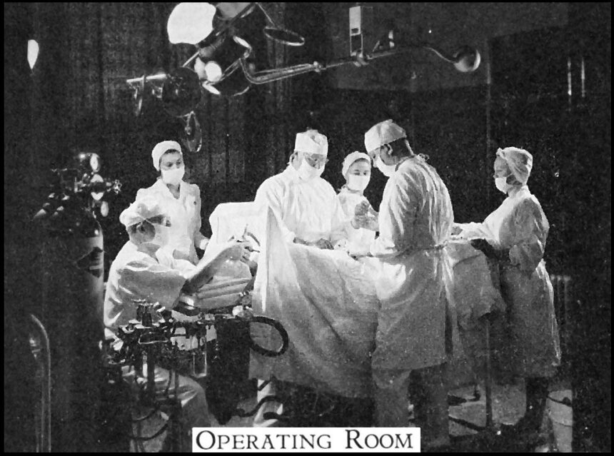 Inside a modern hospital surgical operating room with overhead lights and medical instrumentation