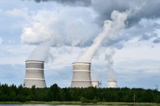 Exterior view of commercial nuclear power plant cooling towers generating baseload electricity