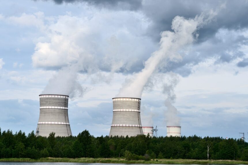 Exterior view of commercial nuclear power plant cooling towers generating baseload electricity