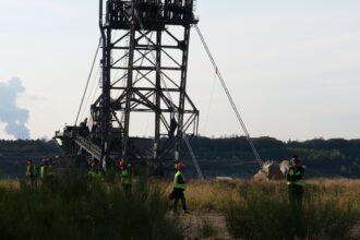 Large-scale mining excavator operating at an open-pit mineral excavation facility
