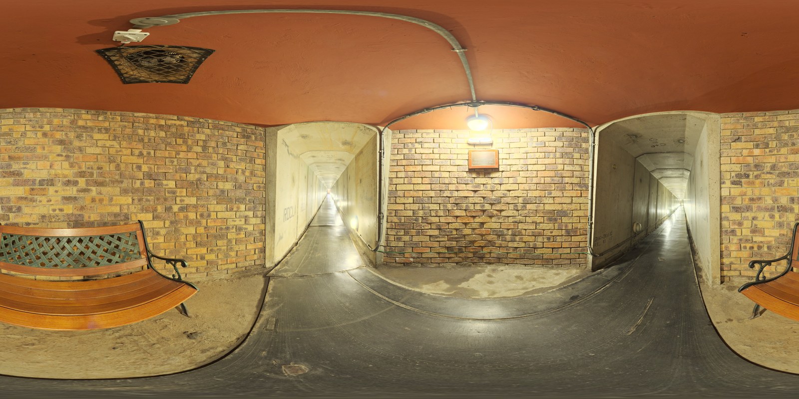 Interior view of an underground reinforced concrete passage tunnel with linear lighting