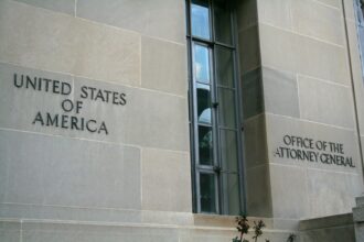 Exterior signage and stonework of the Robert F. Kennedy Department of Justice Building in Washington, D.C.