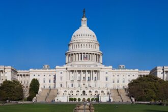 Full view of the United States Capitol building under blue skies in Washington D.C.
