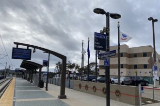 American flags flying in front of a Department of Veterans Affairs medical center hospital building
