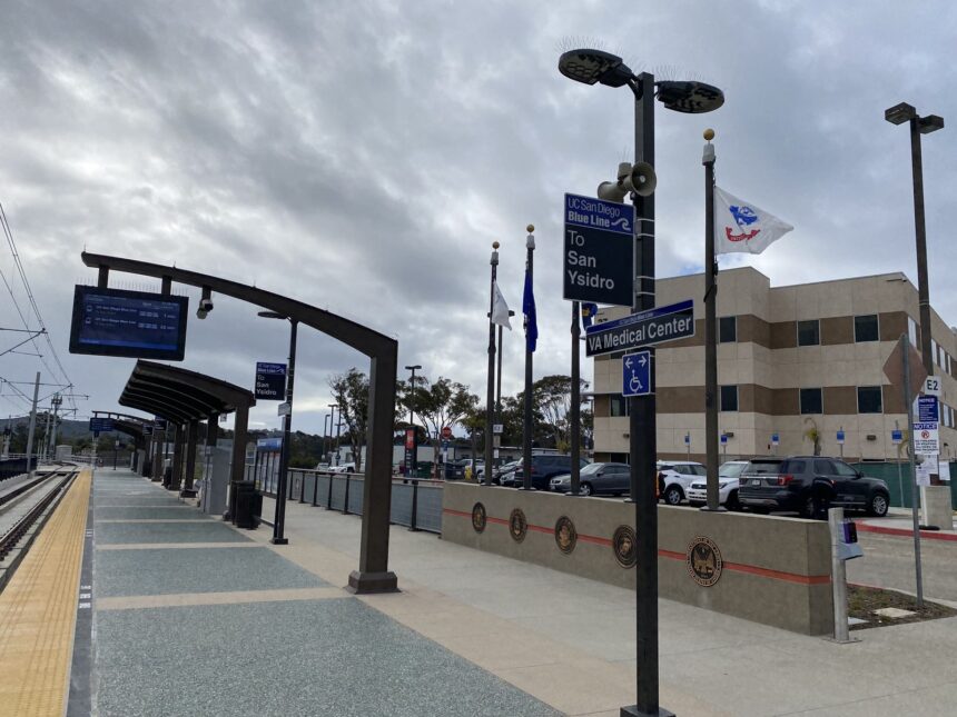 American flags flying in front of a Department of Veterans Affairs medical center hospital building